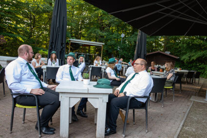 Schützen sitzen gesellig zusammen in einem Biergarten in Jever