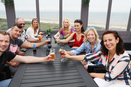 Gruppe sitz auf Terasse mit Merblick in Wijk aan Zee